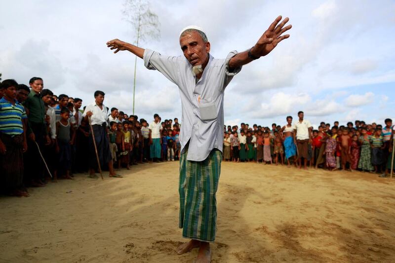 A Rohingya Muslim man performs a dance before the start of a fight as part of a traditional wrestling festival at Kyaukpannu village in Maungdaw, northern Rakhine state. Soe Zeya Tun / Reuters