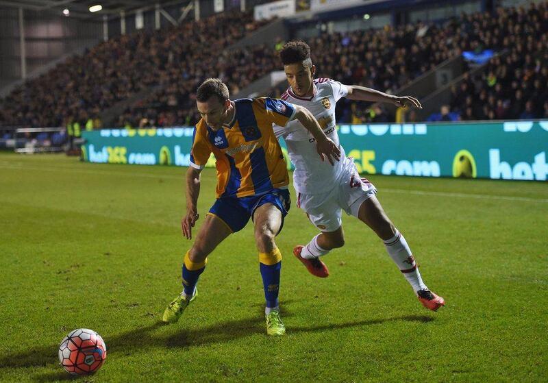 SHREWSBURY, ENGLAND - FEBRUARY 22:  Shaun Whalley of Shrewsbury Town holds off Cameron Borthwick-Jackson of Manchester United during the Emirates FA Cup fifth round match between Shrewsbury Town and Manchester United at Greenhous Meadow on February 22, 2016 in Shrewsbury, England.  (Photo by Michael Regan/Getty Images)