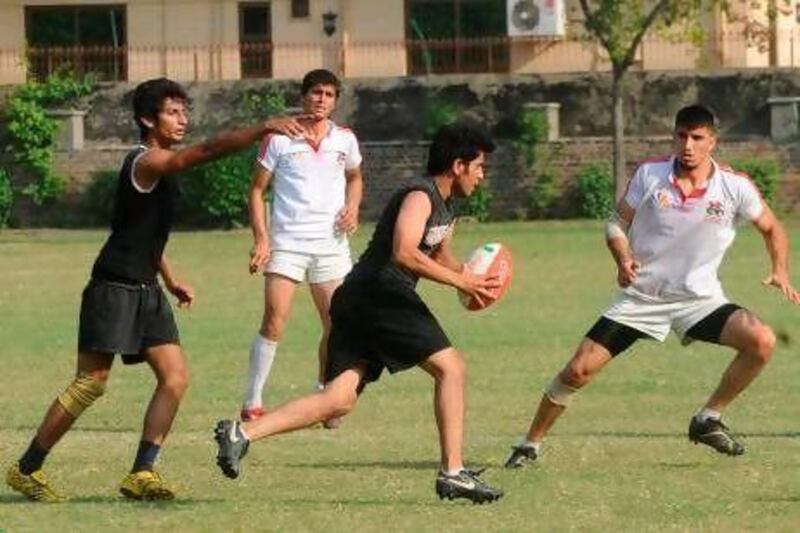 Afghanistan, in white, has traveled to tournaments to face other seven-a-side teams such as Pakistan, in black.