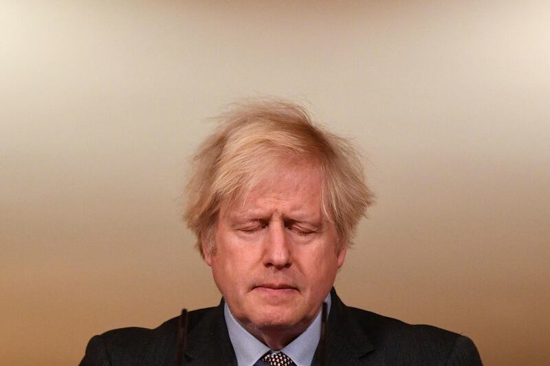 Britain's Prime Minister Boris Johnson closes his eyes as he leads a virtual press conference on the Covid-19 pandemic, from inside 10 Downing Street in central London. AP