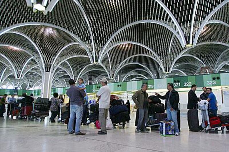 Passengers check in at Baghdad International Airport.