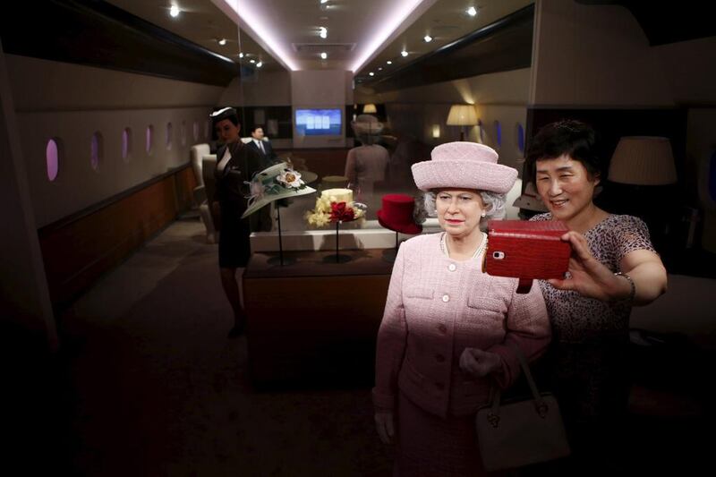 A woman takes a selfie with the wax figure of Britain’s Queen Elizabeth II at Grevin Wax Museum in Seoul, South Korea on July 30, 2015. Kim Hong-Ji / Retuers