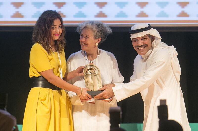 Shahad Ameen, left, is presented with her award for winning the short narrative in the Emirates Film Competition. Mona Al-Marzooqi/ The National