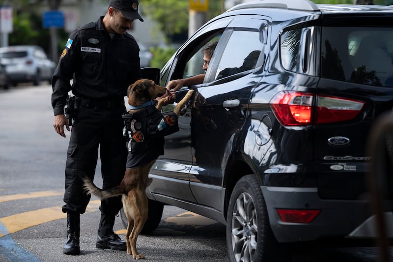 Sgt Cristiano de Oliveira greets drivers who stop especially to pet Olveira,