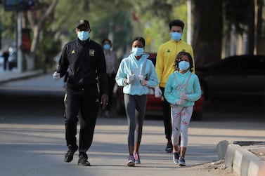 A family takes a walk in the upscale Zamalek neighbourhood of Cairo. Many people have taken to outdoor exercise after measures to control the coronavirus reduced traffic and cleared the air in Egypt's capital. Reuters