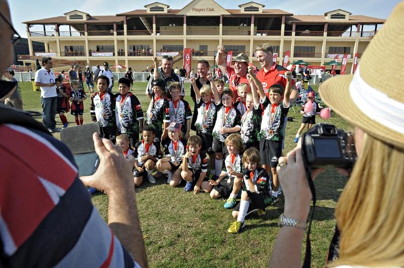 Parents take photos of the Abu Dhabi Harlequins team during the festival. Jeff Topping for The National
