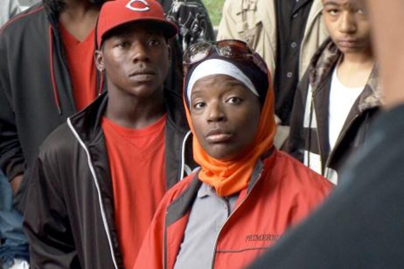 Amena Matthews (with head covered) one of The Interrupters, a group of ex-criminals fighting violence on the Chicago streets". Photo Courtesy Cinema Guild