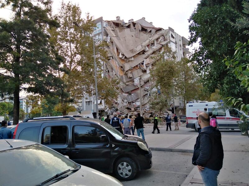 Locals look at a damaged building in Izmir. Reuters