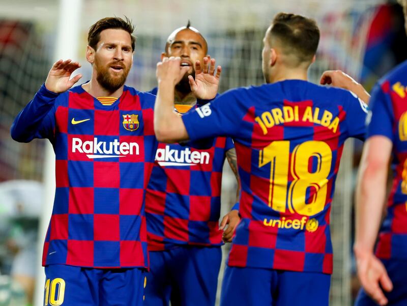 Barcelona's Jordi Alba, right, celebrates with Barcelona's Lionel Messi. AP Photo
