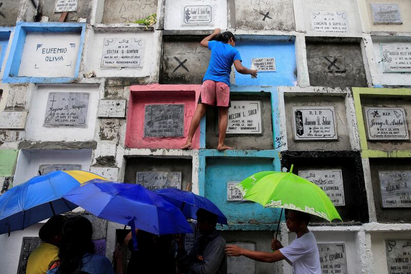 People visit apartment-style tombs of their loved ones during the observance of All Saints day at Navotas Public cemetery in Metro Manila, Philippines. Romeo Ranoco / Reuters