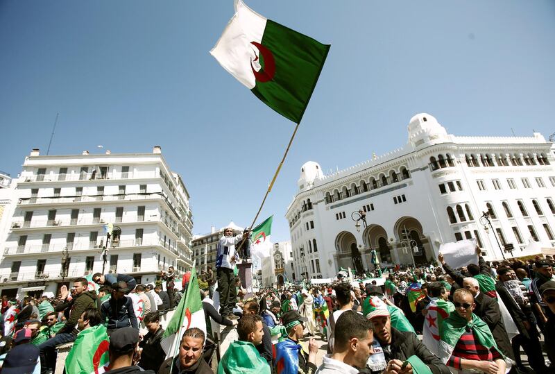 People carry national flags during a protest to demand the removal of President Abdelaziz Bouteflika in Algiers, Algeria March 29, 2019. REUTERS/Ramzi Boudina