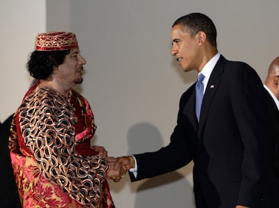 U.S. President Barack Obama shakes hands with Libya's leader Muammar Gaddafi (L) before a dinner at the G8 summit in L'Aquila in this July 9, 2009 file photo. Gaddafi died of wounds suffered on October 20, 2011 as fighters battling to complete an eight-month-old uprising against his rule overran his hometown Sirte, Libya's interim rulers said. His killing, which came swiftly after his capture near Sirte, is the most dramatic single development in the Arab Spring revolts that have unseated rulers in Egypt and Tunisia and threatened the grip on power of the leaders of Syria and Yemen. REUTERS/Alessandro Bianchi/Files (ITALY - Tags: POLITICS) *** Local Caption ***  SIN308_LIBYA_1020_11.JPG