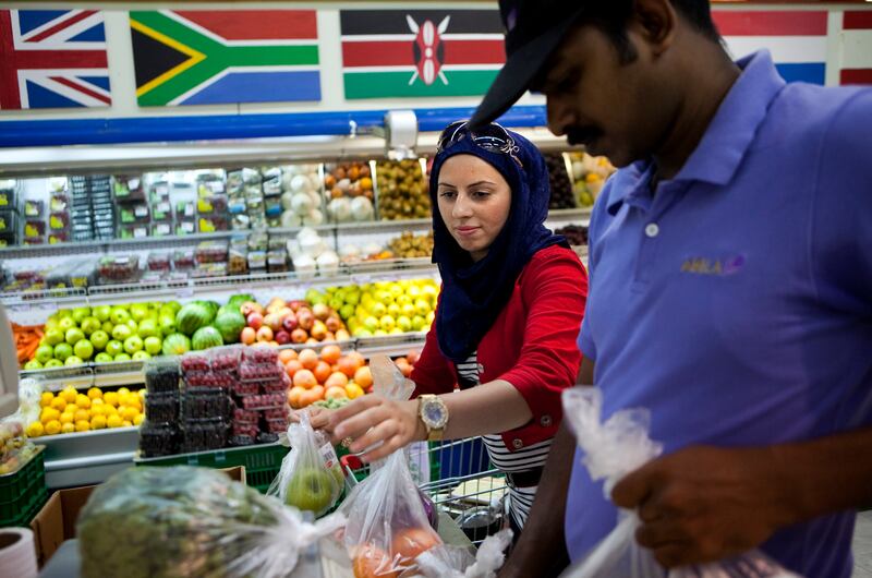 Jordanian by descent, but born and raised in the Khalidiya neighbourhood in Abu Dhabi, Hanan Hasan shops for food at the Abela Supermarket, a 30-year fixture to the neighborhood in Abu Dhabi on Sunday, July 31, 2011., the last day before the start of Ramadan. (Silvia Razgova/The National)

