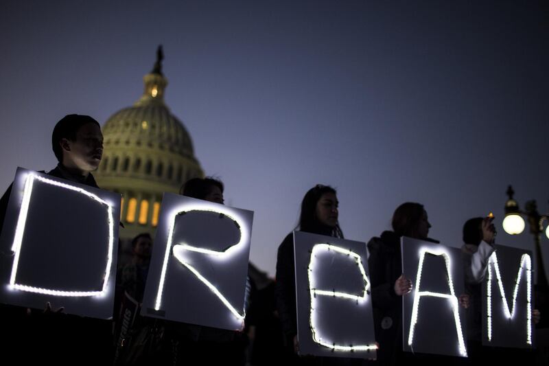 Demonstrators hold illuminated signs during a rally supporting the Deferred Action for Childhood Arrivals program (DACA), or the Dream Act, outside the U.S. Capitol building in Washington, D.C., U.S., on Thursday, Jan. 18, 2018. The House passed a spending bill Thursday to avoid a U.S. government shutdown, but Senate Democrats say they have the votes to block the measure in a bid to force Republicans and President Donald Trump to include protection for young immigrants. Photographer: Zach Gibson/Bloomberg