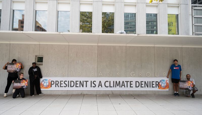 Activists stage a protest at the World Bank headquarters in Washington, calling for world leaders to fire World Bank president David Malpass after his statements casting doubt on climate change. AP
