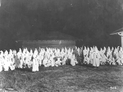 circa 1920:  A meeting of the hooded members of the American white supremecist movement, the Ku Klux Klan (KKK).  (Photo by Hulton Archive/Getty Images)