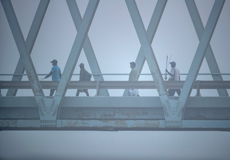 Anglers cross Iron Bridge at Yas Island.
