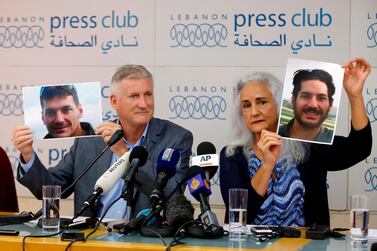 Marc and Debra Tice, the parents of Austin Tice who has been missing in Syria since August 2012, holds up photos of him during a news conference at the Press Club, in Beirut. AP, File