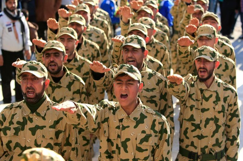 FILE - In this February 18, 2017 file photo, Hezbollah fighters parade during a ceremony to honor fallen comrades, in Tefahta village, south Lebanon. A Hezbollah official says multimillion dollar rewards offered by the Trump administration in return for information leading to the arrest of its operatives are part of ongoing U.S. efforts to "demonize" the group. He also said such false accusations as well as U.S. sanctions imposed on the group will not have any effect on its operational activities. (AP Photo/Mohammed Zaatari, File)