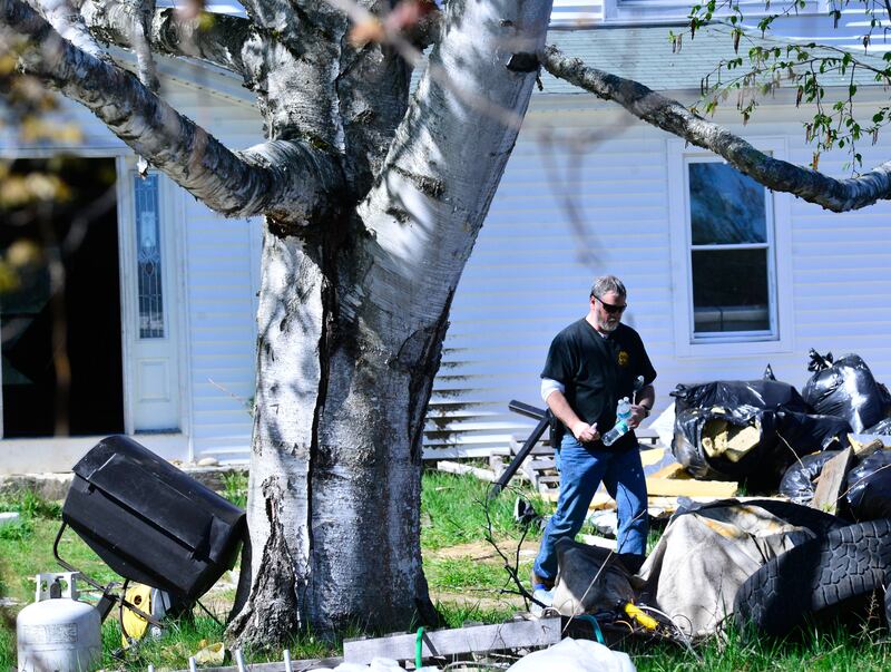Federal agents search Mr Carman's house for evidence. The Brattleboro Reformer / AP