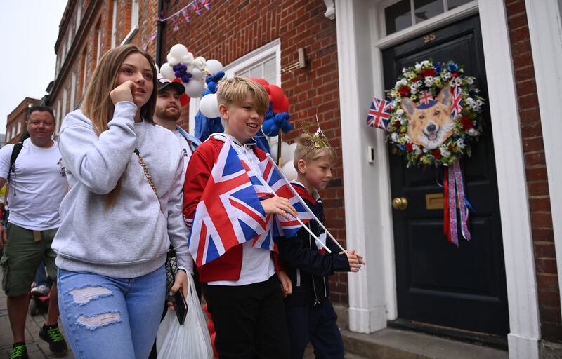 Revellers celebrate near Windsor Castle, Britain. EPA 