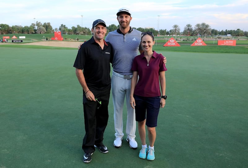 ABU DHABI, UNITED ARAB EMIRATES - JANUARY 18: Sam Bush of Australia and his wife Vanessa pose with  Dustin Johnson of the United States on the 18th green during the pro-am for the 2017 Abu Dhabi HSBC Golf Championship at Abu Dhabi Golf Club on January 18, 2017 in Abu Dhabi, United Arab Emirates.  (Photo by David Cannon/Getty Images)