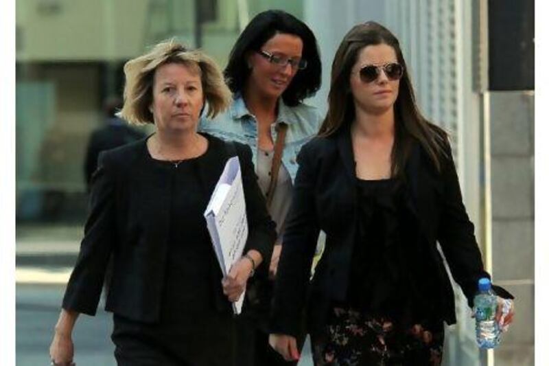Jennifer Green, right, arrives at Manchester Magistrates Court yesterday. She is the girlfriend of the alleged ringleader of the blackmail scheme. Paul Ellis / AFP