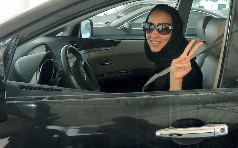 TO GO WITH AFP STORY BY ACIL TABBARA 
Saudi activist Manal Al Sharif, who now lives in Dubai, flashes the sign for victory as she drives her car in the Gulf Emirate city on October 22, 2013, in solidarity with Saudi women preparing to take to the wheel on October 26, defying the Saudi authorities, to campaign women's right to drive in Saudi Arabia. Under the slogan " driving is a choice ", activists have called on social networks for women to gather in vehicles on October 26, the culmination of the campaign launched in September, in the only country in the world where women do not have the right drive. AFP PHOTO/MARWAN NAAMANI / AFP PHOTO / MARWAN NAAMANI