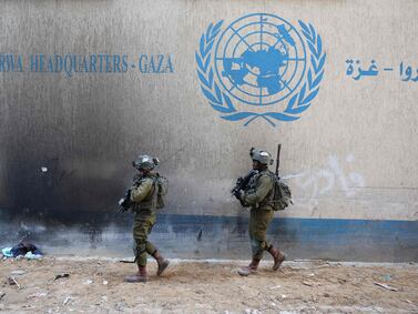 --PHOTO TAKEN DURING A CONTROLLED TOUR AND SUBSEQUENTLY EDITED UNDER THE SUPERVISION OF THE ISRAELI MILITARY-- This picture taken during a media tour organised by the Israeli army on February 8, 2024, shows Israeli soldiers inside a compound of the United Nations Relief and Works Agency for Palestine Refugees (UNRWA) in the Gaza Strip, amid ongoing fighting between Israel and the Palestinian militant group Hamas.  (Photo by JACK GUEZ  /  AFP)