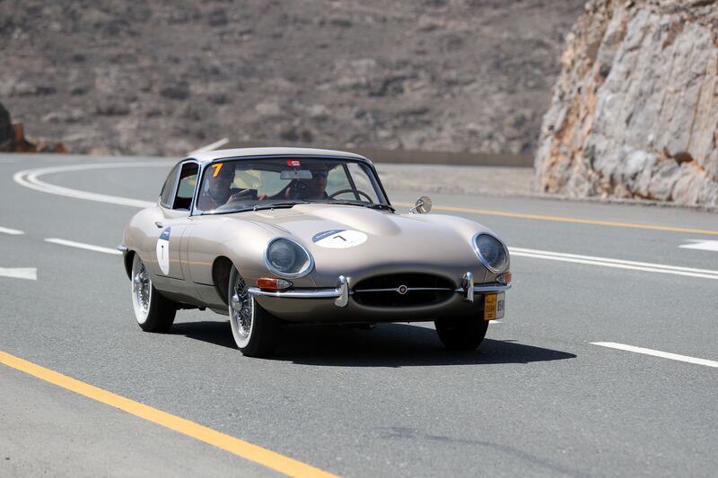 A 1964 E-type Jaguar climbs Jebel Jais.