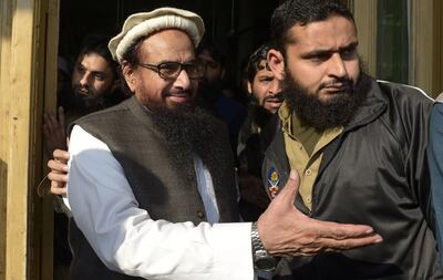 Pakistani head of the Jamaat-ud-Dawa (JuD) organisation Hafiz Saeed (L) arrives to offer Friday prayers at Jamia AL Qadsia Masjid following his released in Lahore on November 24, 2017.

A Pakistani court on November 23 ordered the release of one of the alleged masterminds of the 2008 Mumbai attacks which killed more than 160 people, after months of US pressure on Islamabad over its alleged support for militants. Firebrand cleric Hafiz Saeed, who heads the UN-listed terrorist group Jamaat-ud-Dawa (JuD) and has a $10 million US bounty on his head, will be freed tomorrow after less than a year in detention following the decision by the Lahore High Court, a JuD official said. / AFP PHOTO / STR