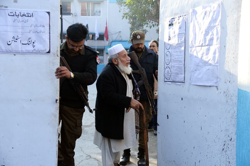 Pakistani security officials guard a polling station in Lahore. EPA