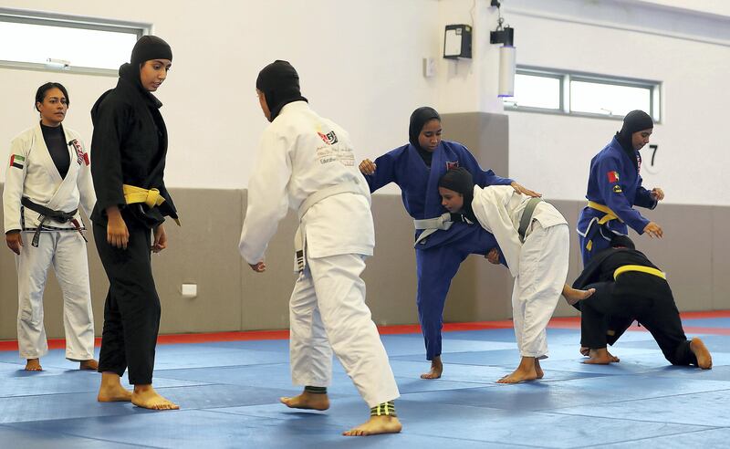 ABU DHABI , UNITED ARAB EMIRATES , AUG 27 – 2017 :-  Rosalind Ferreira , coach ( left ) giving tips during the training of UAE women’s junior national Jiu Jitsu team at the Arena at Zayed Sports City in Abu Dhabi. ( Pawan Singh / The National ) Story by Amith Passela