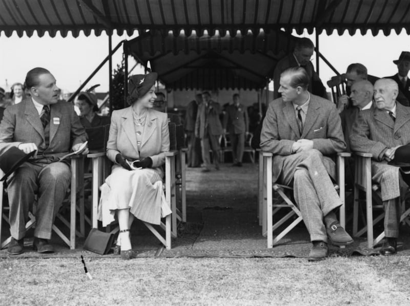 Princess Elizabeth talking to Prince Philip (second right), the Duke of Edinburgh, at the Royal Horse Show at Windsor, England, May 12th 1949. (Photo by Douglas Miller/Keystone/Getty Images)