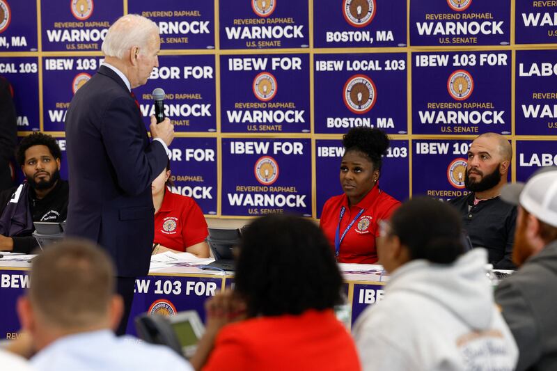 US President Joe Biden takes part in an International Brotherhood of Electrical Workers (IBEW) phone bank for Mr Warnock in Boston, Massachusetts. Reuters