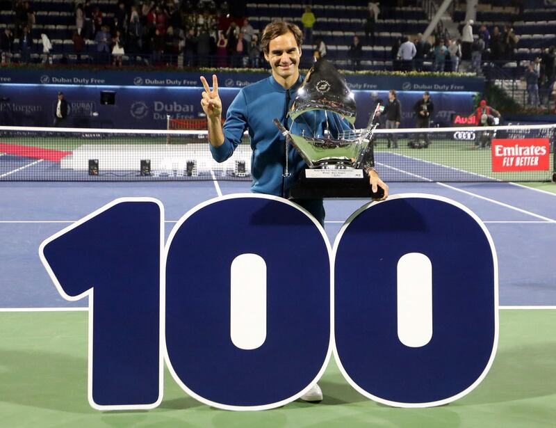 Switzerland's Roger Federer celebrates with the trophy after winning the final match at the ATP Dubai Tennis Championship in the Gulf emirate of Dubai on March 2, 2019. Roger Federer won his 100th career title when he defeated Greece's Stefanos Tsitsipas 6-4, 6-4 in the final of the Dubai Championships. / AFP / KARIM SAHIB
