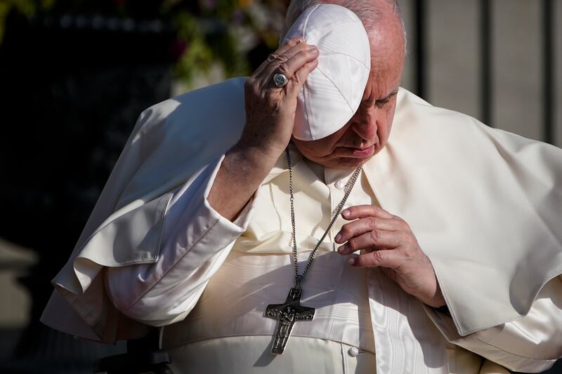 Pope Francis holds onto his skull cap, or zucchetto, as the wind blows during his visit to the Citadelle de Quebec in Quebec City on Friday, part of a six-day penitential visit to Canada to beg forgiveness from survivors of abuse in the country's Catholic-run Indigenous residential schools. AP