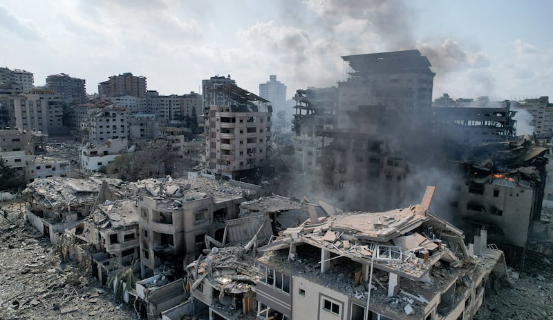 Smoke near houses and buildings destroyed by Israeli strikes in Gaza city. Reuters