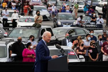 US President Joe Biden speaks during the Democratic National Committee's 'Back on Track' drive-in car rally to celebrate the president's 100th day in office at the Infinite Energy Centre in Duluth, Georgia. Reuters