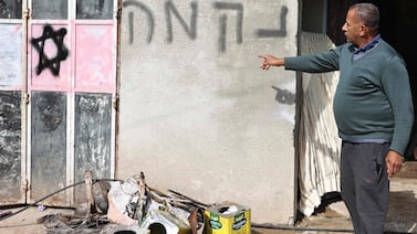 A slogan in Hebrew and graffiti are daubed on the wall of a Palestinian house after an attack by illegal Israeli settlers in Al Lubban ash-Sharqiya in the occupied West Bank. AFP
