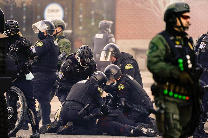 Law enforcement personnel detain an anti-fascist protester during political clashes in Olympia, Washington. AFP