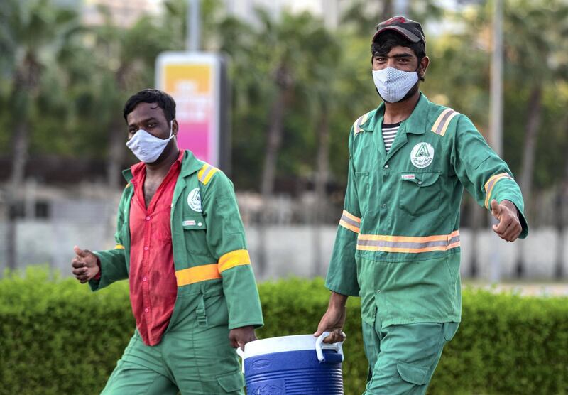 Workers with a jug of water on their way to work on a humid morning,Tuesday, June 8, 2021 in central Abu Dhabi. Victor Besa / The National.