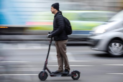 LONDON, ENGLAND - JANUARY 11: A man scoots near Southwark Bridge on an electric scooter on January 11, 2019 in London, England. In the UK, electric scooters and similar powered transporters are still classified as 'motor vehicles,' subject to the same regulations. This makes them illegal to operate in pedestrian areas and bicycle lanes, and imposes strict licensing requirements on potential road use. Despite the current prohibitive regulations, many commuters have turned towards scooters as an alternative mode of travel. (Photo by Dan Kitwood/Getty Images)