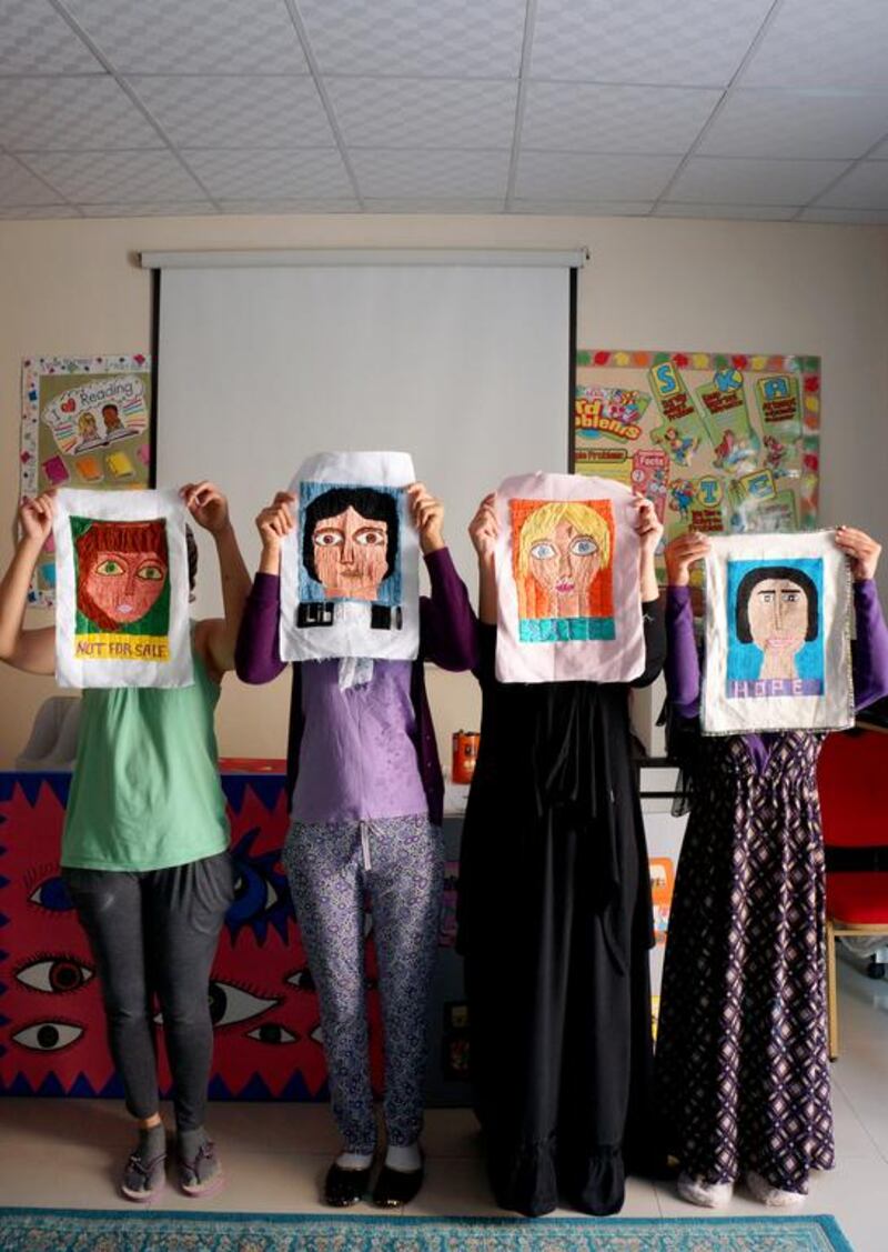 These women, victims of human trafficking, are creating artwork to exhibit in an exhibition show called Silent Voices. Delores Johnson / The National 