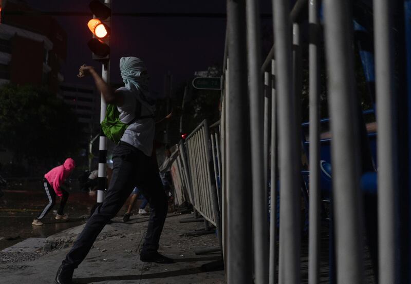 Demonstrators clash with police outside the Estadio Olimpico Romelio Martinez. Reuters