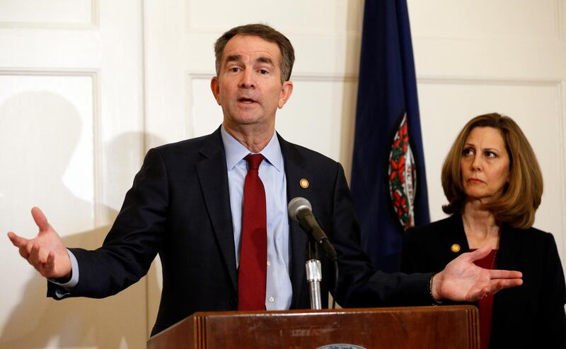 Virginia Gov. Ralph Northam, left, accompanied by his wife, Pam, speaks during a news conference in the Governor's Mansion in Richmond, Va., on Saturday, Feb. 2, 2019. Resisting widespread calls for his resignation, Northam on Saturday vowed to remain in office after disavowing a racist photograph that appeared under his name in his 1984 medical school yearbook. (AP Photo/Steve Helber)