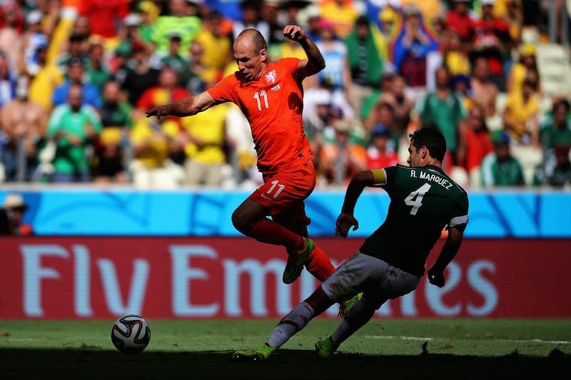 Arjen Robben of the Netherlands is tackled by Rafael Marquez of Mexico during their match at the 2014 World Cup on Sunday. Dean Mouhtaropoulos / Getty Images / June 30, 2014