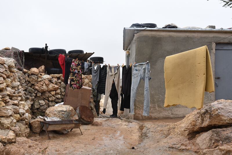 Clothes hang outside the home of the Hamamdi family.