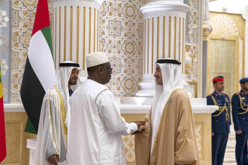 ABU DHABI, UNITED ARAB EMIRATES - February 06, 2020: HH Sheikh Abdullah bin Zayed Al Nahyan UAE Minister of Foreign Affairs and International Cooperation (R) greets HE Macky Sall, President of Senegal (C), during an official visit reception at Qasr Al Watan. Seen with HH Sheikh Mohamed bin Zayed Al Nahyan, Crown Prince of Abu Dhabi and Deputy Supreme Commander of the UAE Armed Forces (L).

( Mohamed Al Hammadi / Ministry of Presidential Affairs )
---