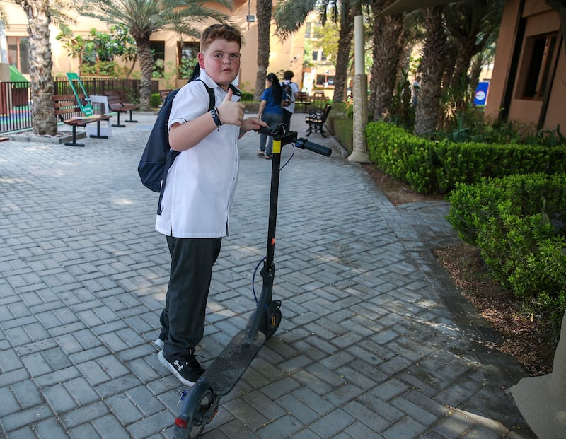 A pupil took a scooter to school on the first day of term. Victor Besa / The National